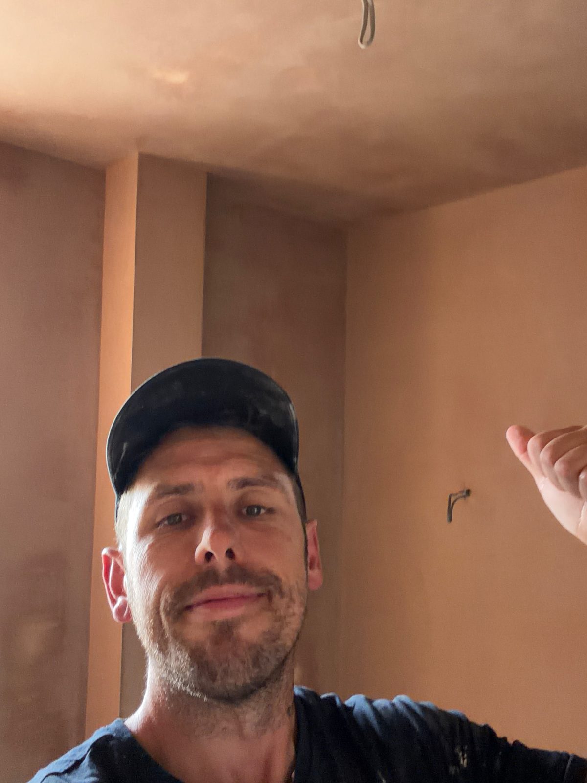 DSB plasterer on site in front of a freshly skimmed wall and ceiling