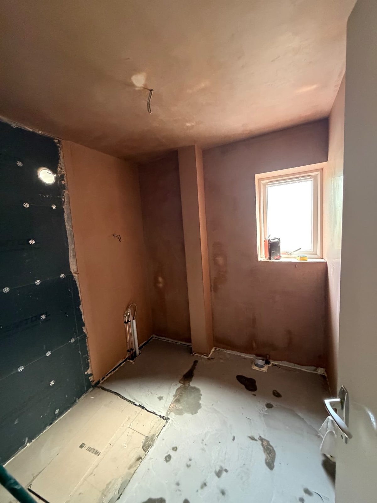 Bathroom walls and ceiling freshly plastered ready for tiling and decorating