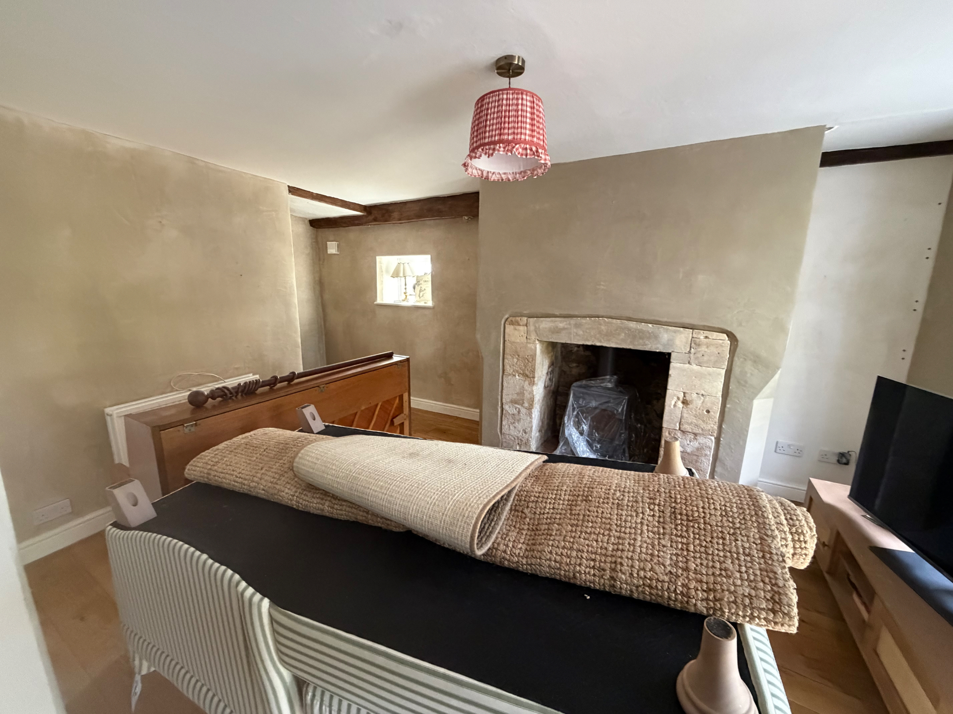 Lime plastered walls finished around the original stone fireplace and exposed floorboards