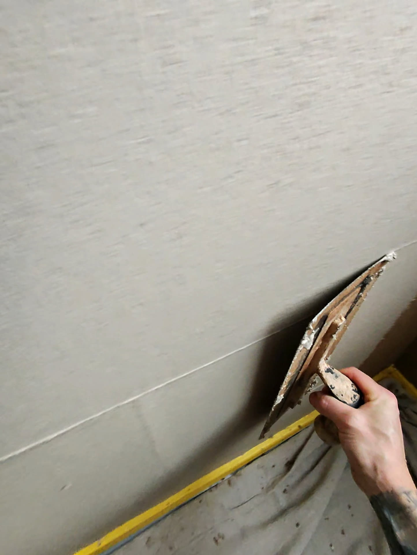 Plaster finish being applied over internal wall insulation