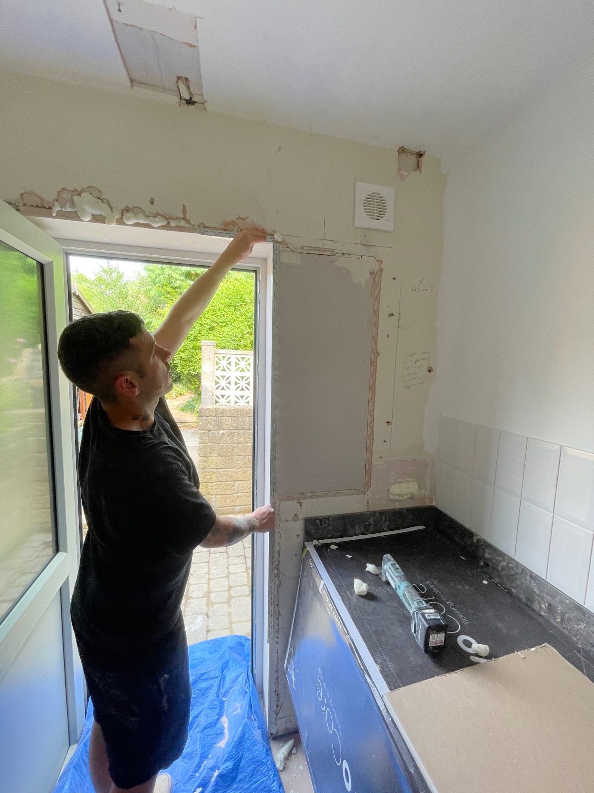 Beading being fitted around a doorway before plastering