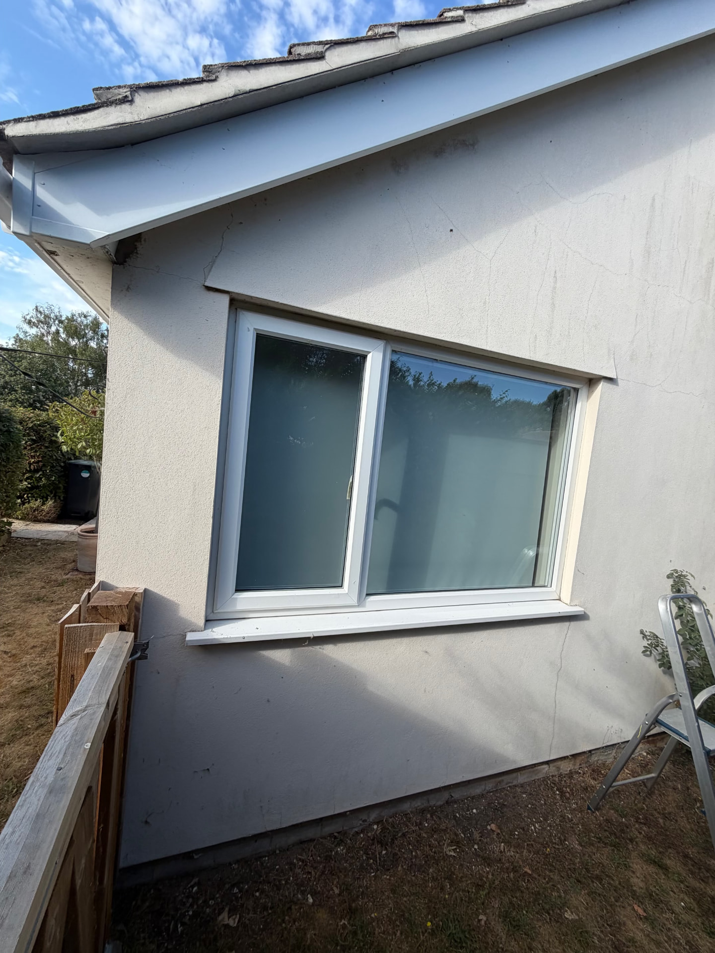 Before work in Frome: cracks above and below the larger window in the existing exterior render