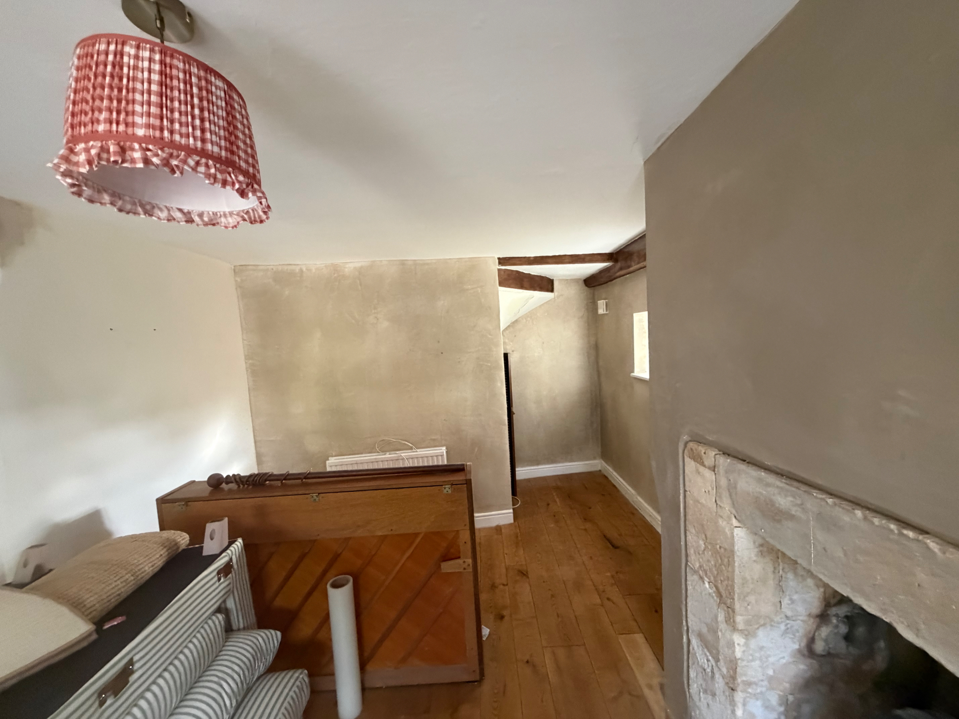 Lime plastered walls beside the staircase, left flat and ready to decorate