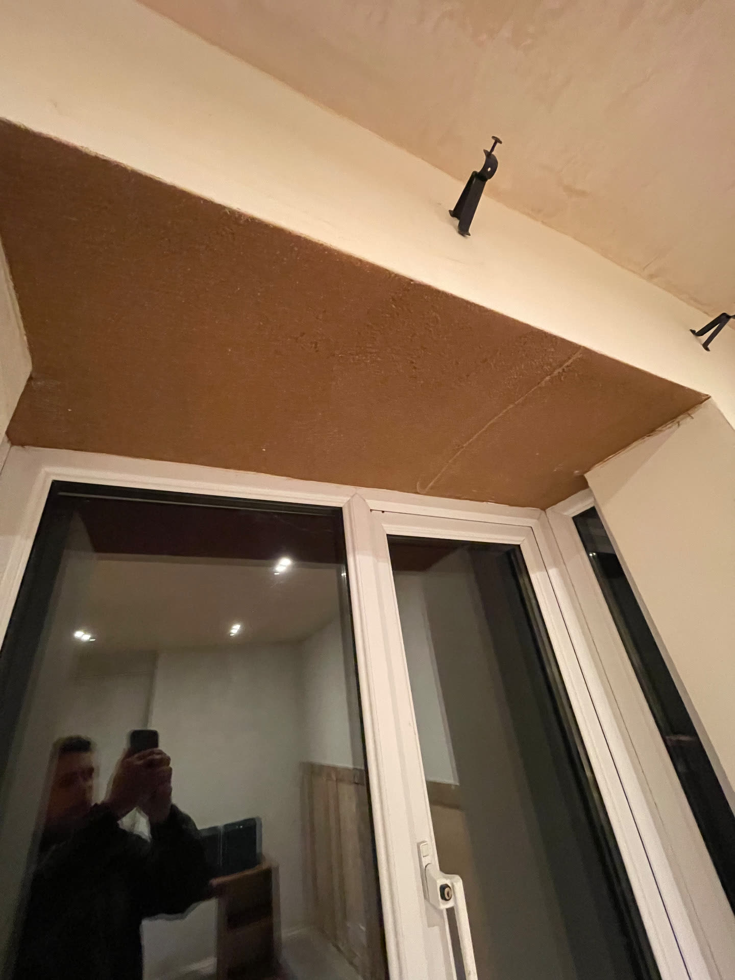 Cork insulation taken across the window head and reveal in a Bath home
