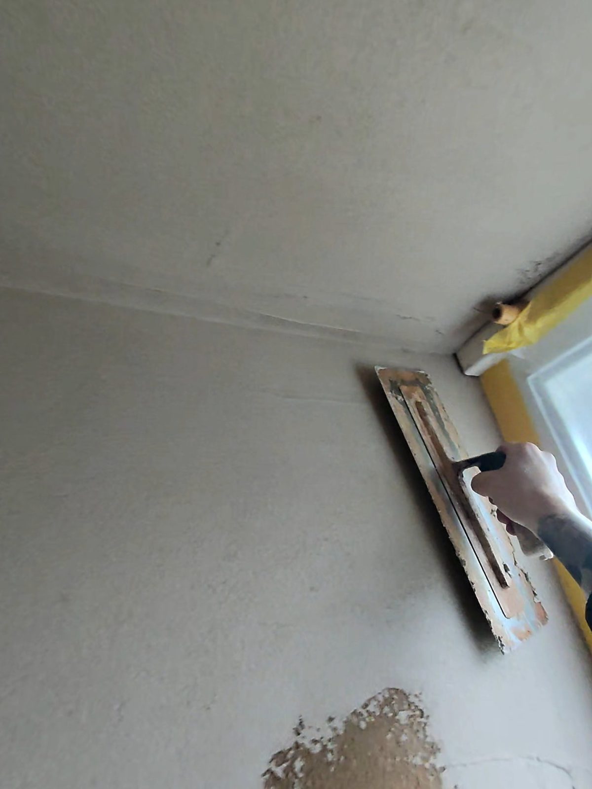 Lime plastered wall and ceiling finished up to the window reveal